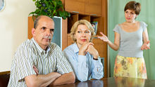Adult child with parents alternate text for this image