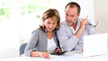Couple with calculator alternate text for this image