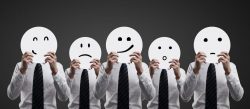 13999500 – businessmens hold plates with smilies on black background alternate text for this image