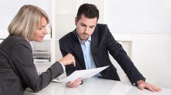 37909742 – business team in a meeting looking at a sheet of paper alternate text for this image