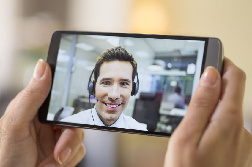 33665611 – closeup of a female hand holding a smart phone during a skype video alternate text for this image