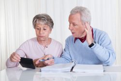 18497183 – stressed senior couple calculating budget at home alternate text for this image