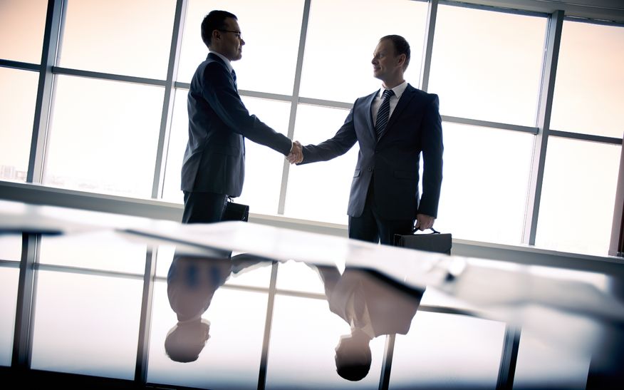 Two businessmen meeting alternate text for this image