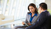 Woman with tablet and client alternate text for this image