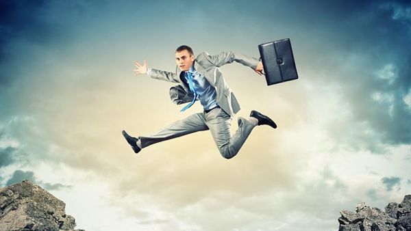 20327316 – image of young businessman jumping over gap alternate text for this image