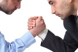 9074552 – arm wrestling in the office isolated on white background. alternate text for this image