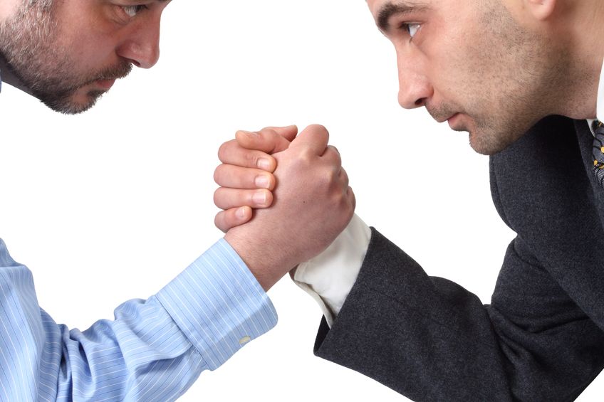 9074552 – arm wrestling in the office isolated on white background. alternate text for this image