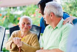 31324767 – elderly woman looking to the carer and her son, the visitor. alternate text for this image