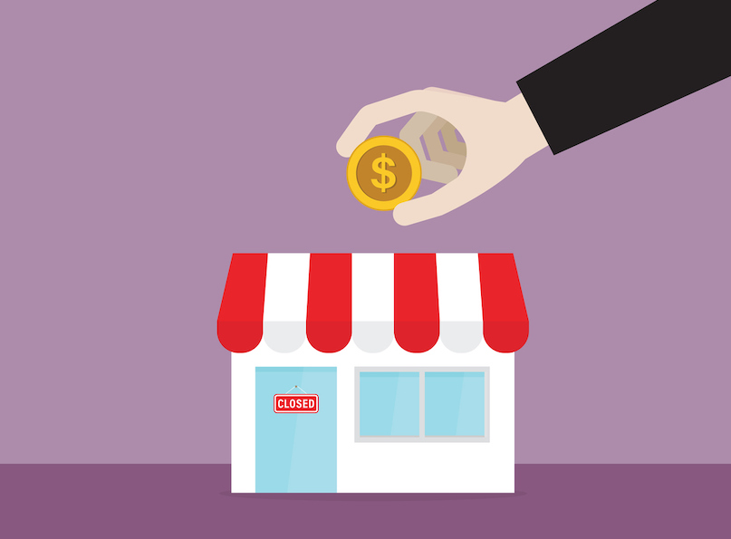 Businessman putting a dollar coin into a shop alternate text for this image