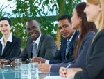 Group of cheerful government representatives working on development of society and discussing policy at meeting