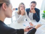 Concerned couple meeting with advisor