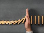 Hand stopping dominos