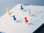 Embroidered red pins on a calendar event Planner calendar,clock to set timetable organize schedule,planning for business meeting or travel planning concept. alternate text for this image
