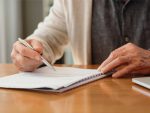 Older person signing a contract