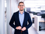 Businessman standing in an office hallway