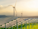 Image of solar and wind turbines farm, in a green field, representing sustainable energy and resources.