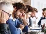 Man looking stressed in an office setting